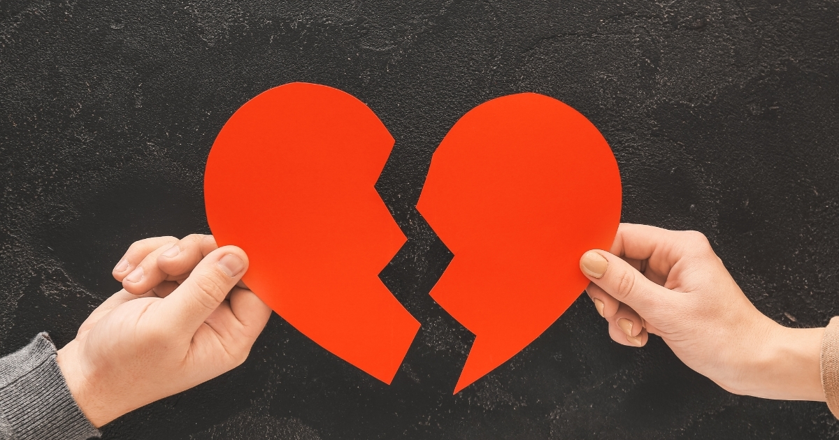 24 How To Improve Yourself After A Breakup - Mature Singles Finding Love Two people holding broken red heart symbolizing breakup and emotional separation
