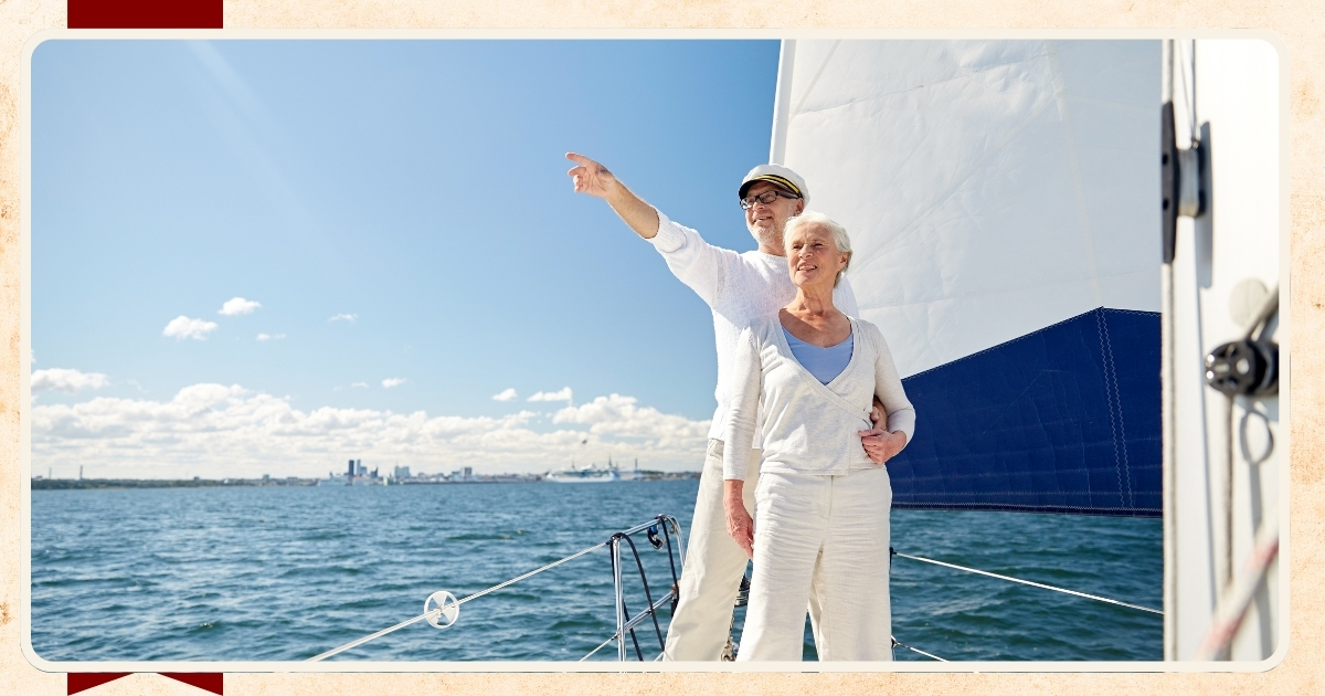 Senior couple sailing on a boat enjoying a sunny day.