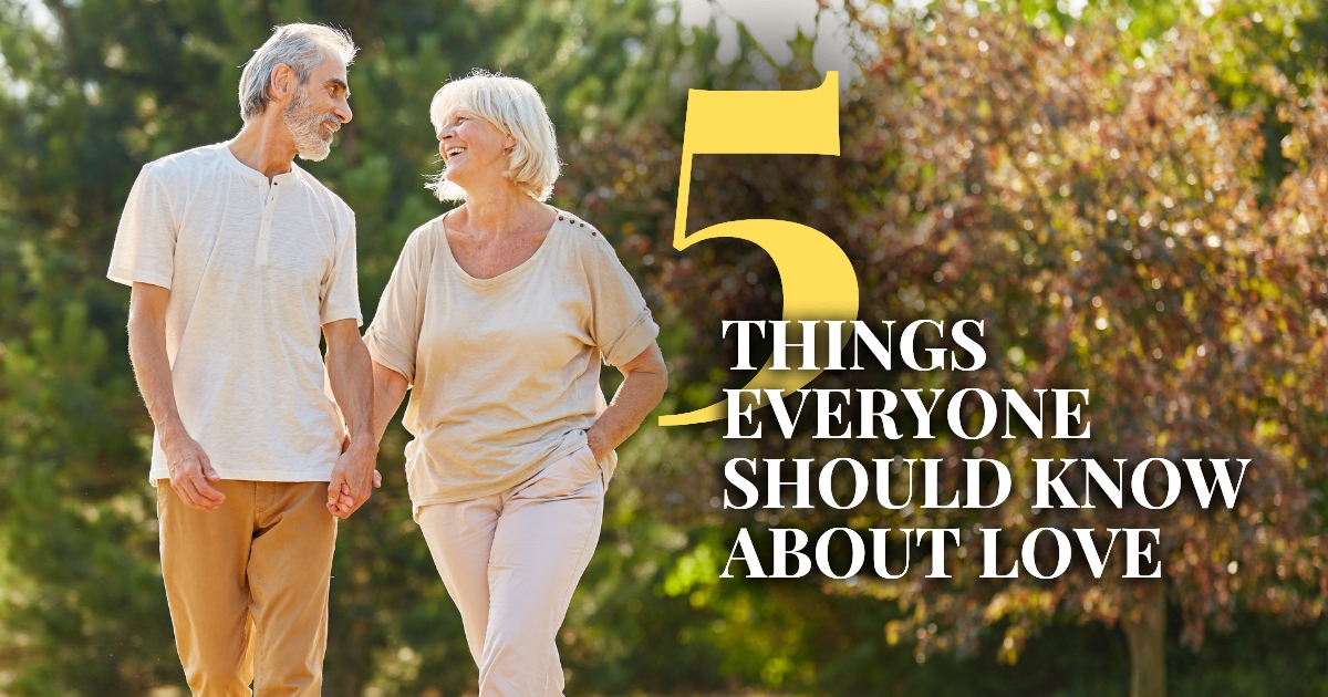 5 Things Everyone Should Know About Love - Mature Singles Finding Love Happy senior couple walking hand in hand, smiling and enjoying a romantic moment outdoors.