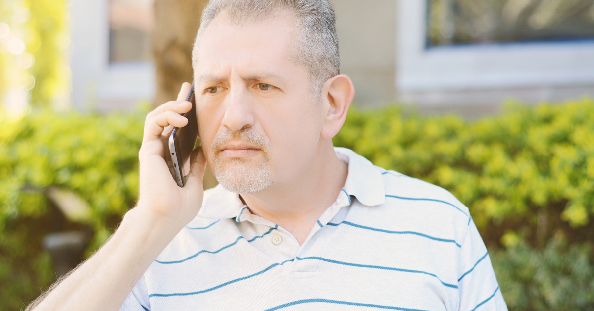 Building Trust in a New Relationship_ Essential Tips - Mature Singles Finding Love Middle-aged man having a serious phone conversation, reflecting on trust and communication in relationships.