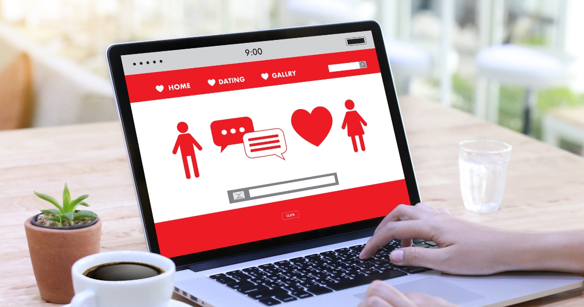Person using a laptop with an online dating website on the screen, featuring icons of people, chat bubbles, and a heart—symbolizing creating a dating profile and finding love online over 50.