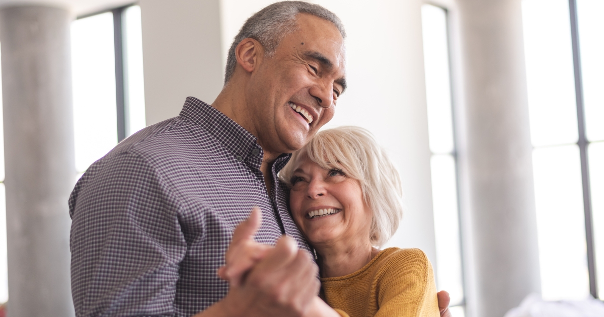 Dating as a Widower or Widow in Your Golden Years - Mature Singles Finding Love Happy senior couple dancing together indoors, symbolizing love, connection, and dating in your golden years after loss.