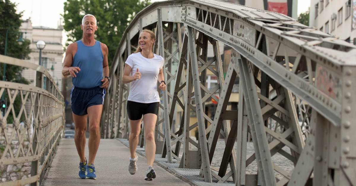 Finding Common Interests with Potential Partners in Your Age Group - Mature Singles Finding Love An older couple jogging together on a bridge, enjoying an active and healthy lifestyle while connecting with each other.