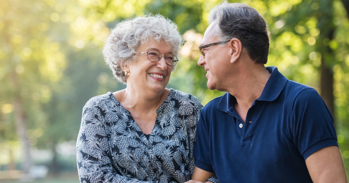 How Clear Expectations Strengthen Relationships - Mature Singles Finding Love Happy mature couple smiling at each other outdoors, representing trust and clear relationship expectations in later life.