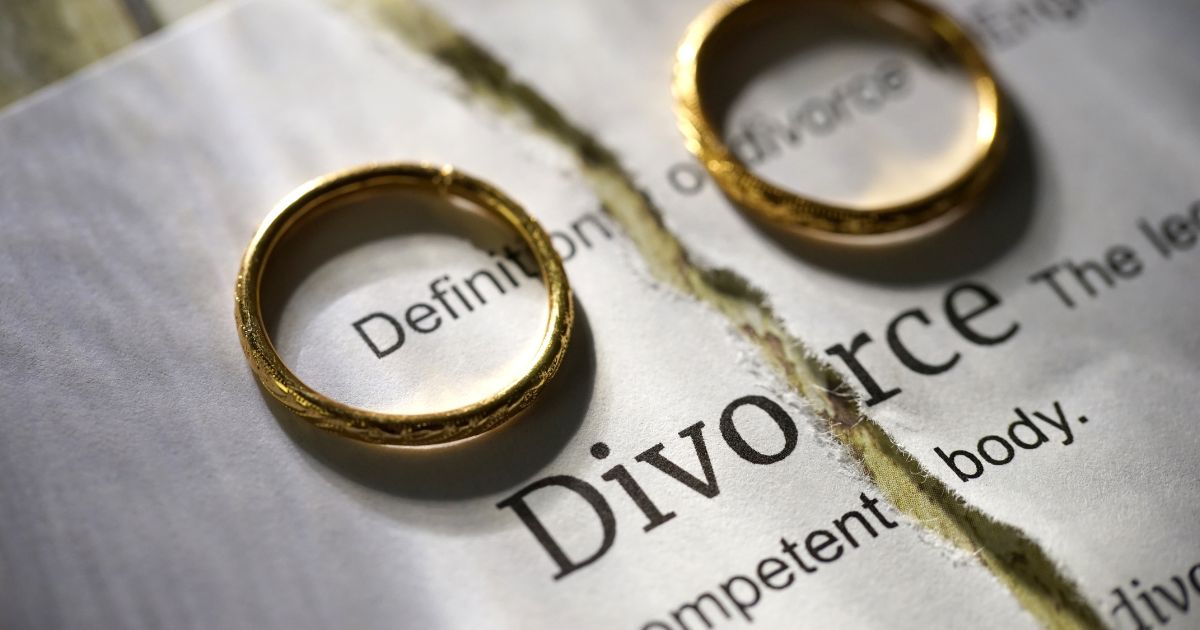 How Soon Is Too Soon To Move On After A Divorce - Mature Singles Finding Love Broken marriage concept – wedding rings on a ripped divorce paper.