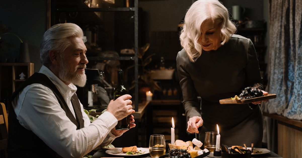 Elegant older couple sharing a romantic candlelit dinner, symbolizing intimacy and connection in later life