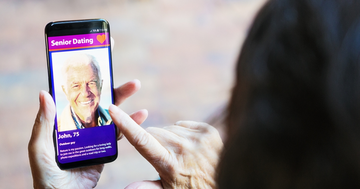 How To Write A Dating Profile That Will Get People To Click - Mature Singles Finding Love Online senior dating profile on a mobile screen.