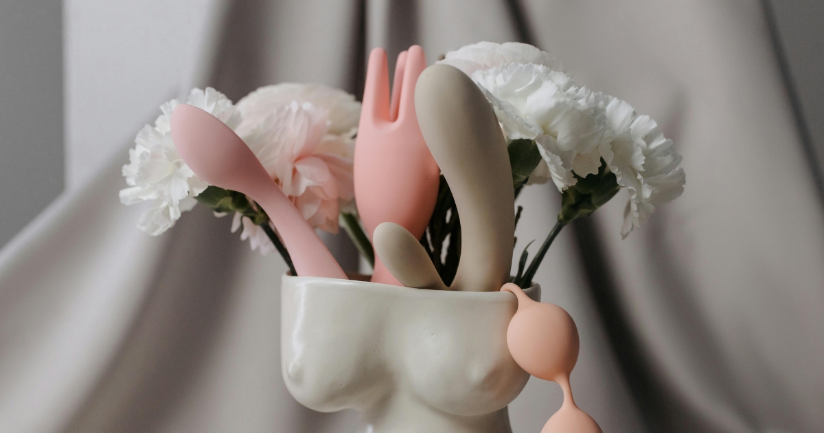 Artistic arrangement of sex toys and flowers representing female empowerment and self-pleasure at any age.