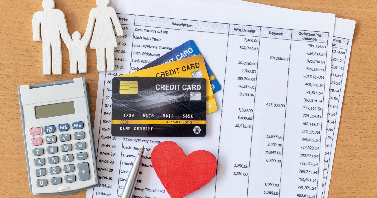 Credit cards, calculator, and financial documents with family cutouts, representing debt management, budgeting, and retirement financial planning.