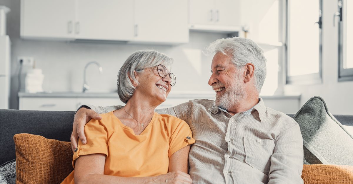 Older couple laughing and enjoying each other's company, illustrating love and connection in mature relationships.