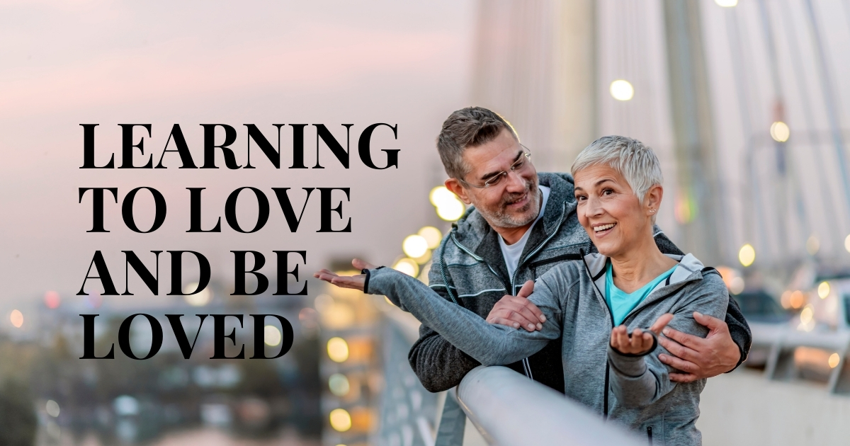 Learning To Love And Be Loved - Mature Singles Finding Love Happy middle-aged couple embracing on a bridge at sunset with text overlay 'Learning to Love and Be Loved,' symbolizing love, relationships, and self-growth.