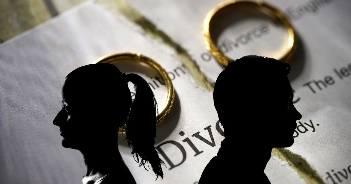 Love in Bloom Again_ Tips for Starting Over After Divorce or Loss - Mature Singles Finding Love Silhouettes of divorced couple over torn divorce paper with wedding rings