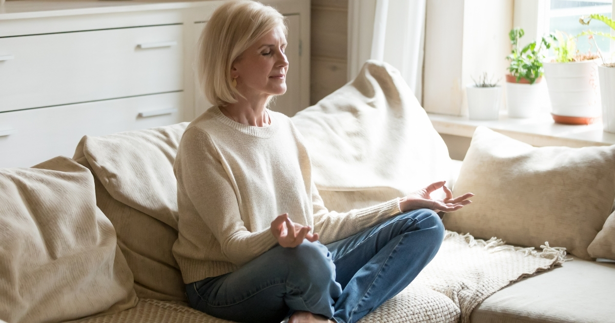 Mindfulness and Meditation for Mature Singles_ Finding Inner Peace and Joy - Mature Singles Finding Love Mature woman practicing mindfulness meditation at home for inner peace and emotional well-being.