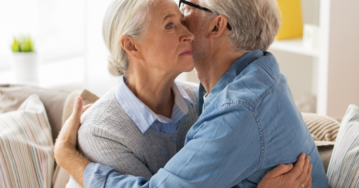 Navigating Relationship Expectations Through Open Communication - Mature Singles Finding Love Older couple sharing a heartfelt embrace during a serious conversation, symbolizing emotional connection and open communication in relationships after 50.