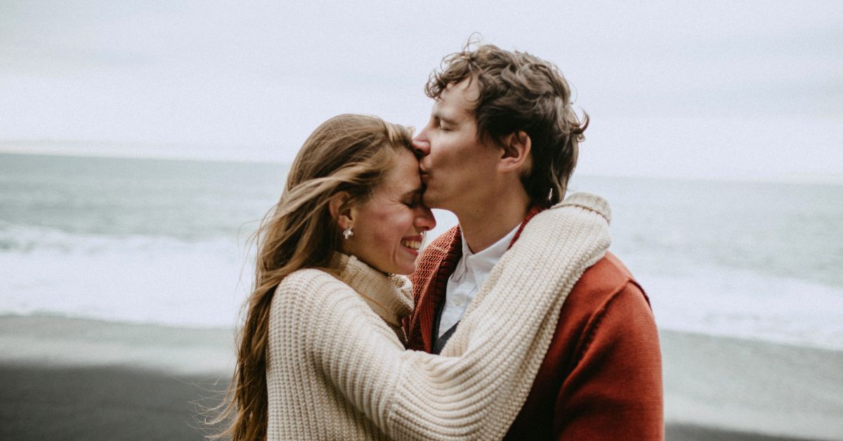 Rediscovering Connection_ Simple Things You Can Do Together to Feel Closer - Mature Singles Finding Love Happy couple embracing and smiling by the ocean, reconnecting and sharing a loving moment
