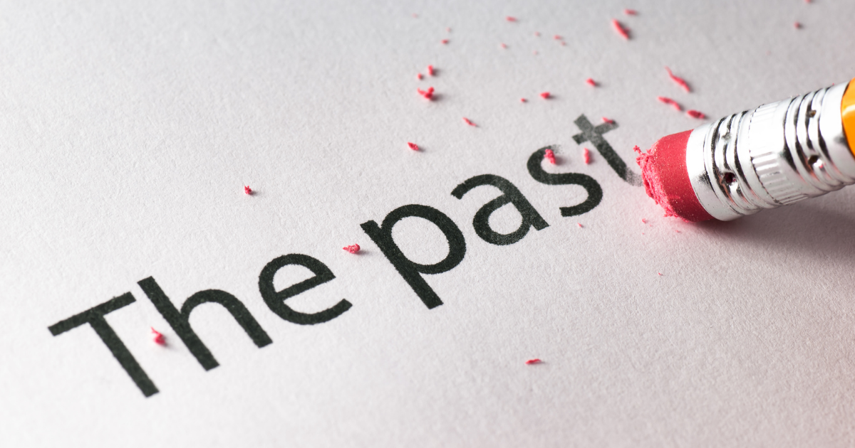 The Impact of Past Relationships on Current Dating Experiences - Mature Singles Finding Love A close-up of a pencil eraser removing the words 'The past' on paper, symbolizing letting go of past experiences and starting fresh.