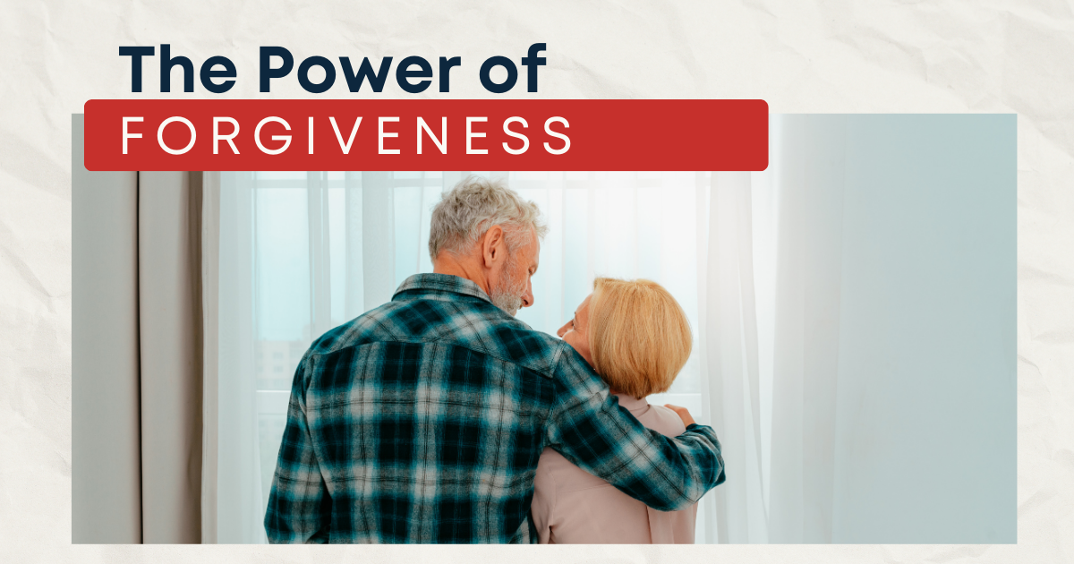 The Power of Forgiveness in Mature Relationships - Mature Singles Finding Love An older couple embracing warmly near a window, with the text 'The Power of Forgiveness' displayed above, symbolizing reconciliation and emotional connection in mature relationships.