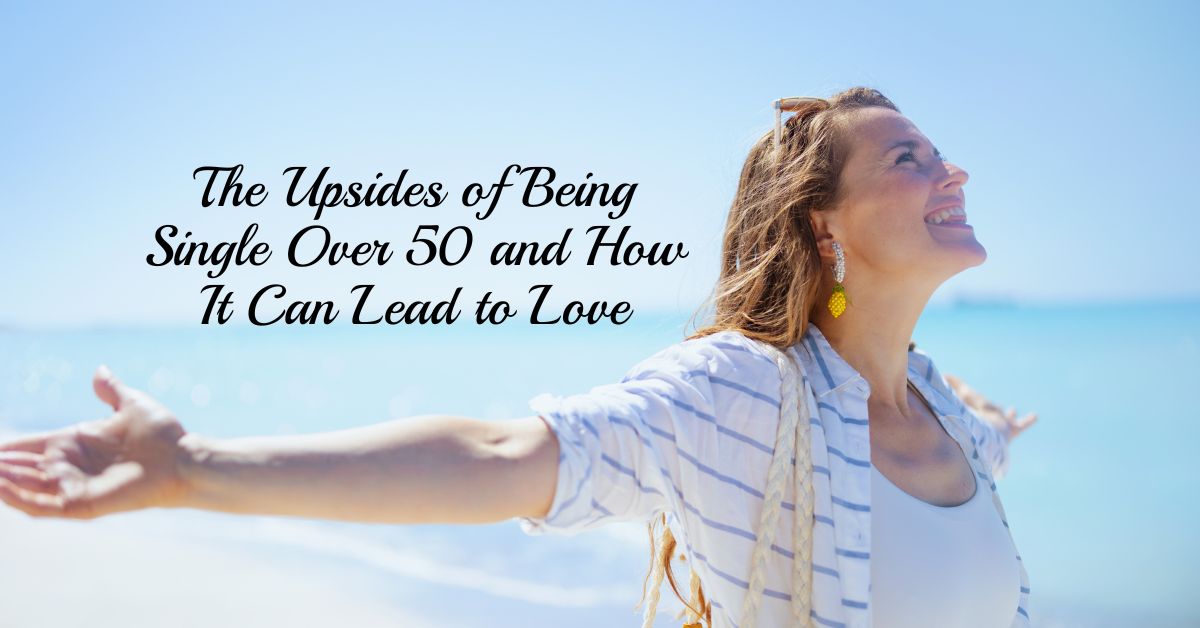 Joyful woman embracing single life over 50 at the beach, symbolizing freedom and self-love.