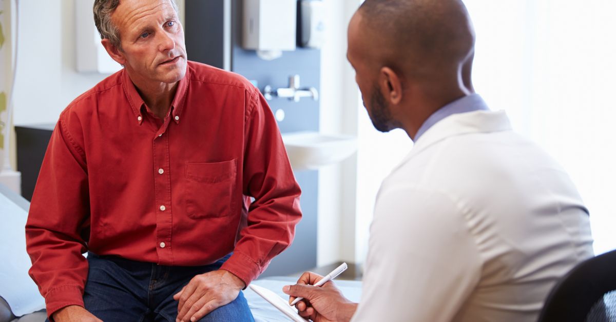 Understanding and Overcoming Erectile Dysfunction_ Support Solutions and Hope - Mature Singles Finding Love Middle-aged man discussing erectile dysfunction with a doctor during a medical consultation — highlighting support, treatment options, and open communication for ED.