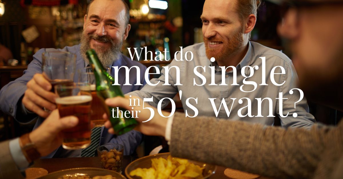 What do Men Single in Their 50s Want - Mature Singles Finding Love Group of mature single men in their 50s smiling and toasting drinks at a bar, with text overlay: 'What do men single in their 50s want?' – representing dating goals and lifestyle for older men.